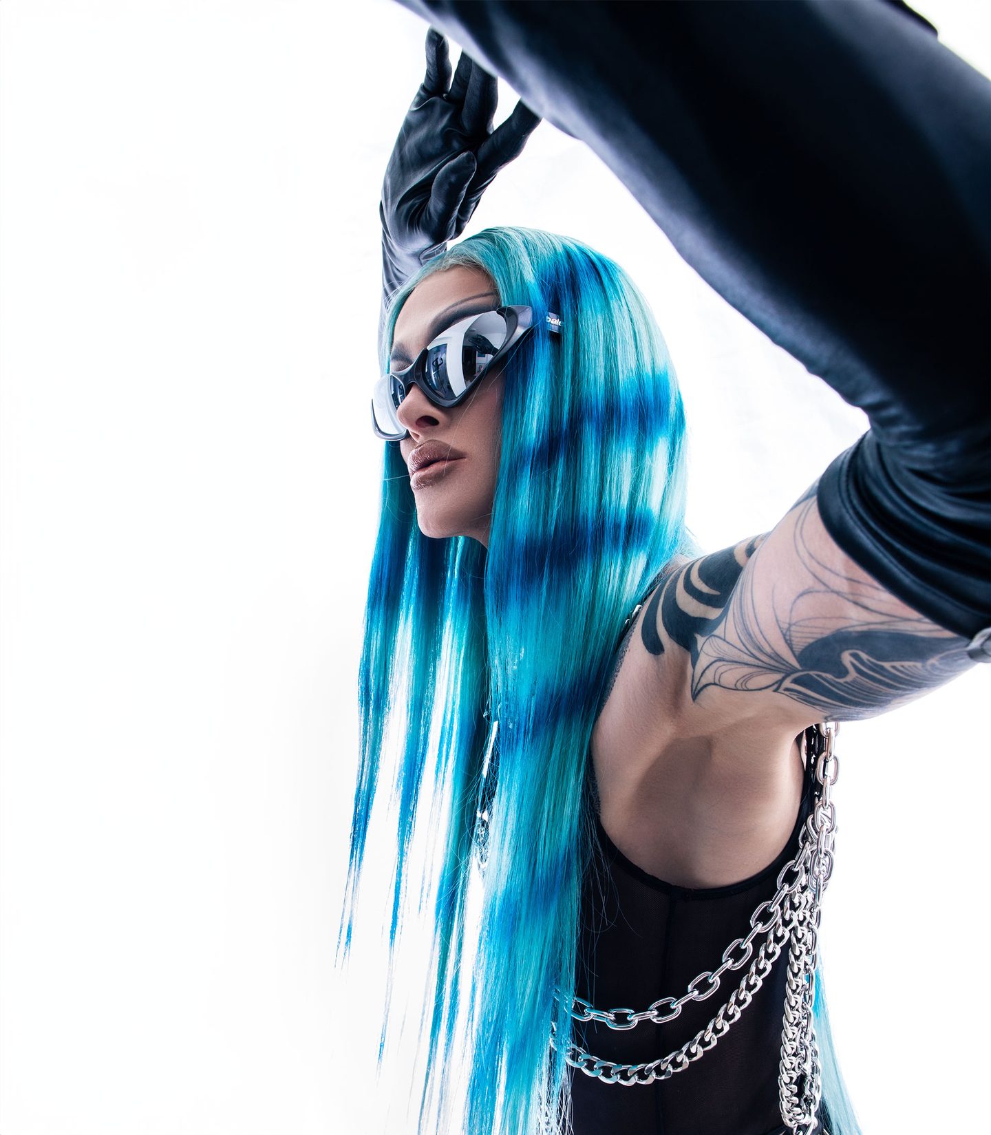 Philisha Conditioner mit blauen Haaren und Sonnenbrille